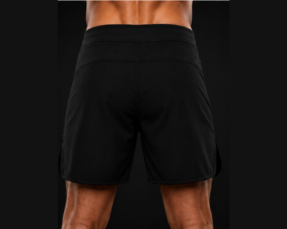 Black athletic shorts worn by a person on a black background
